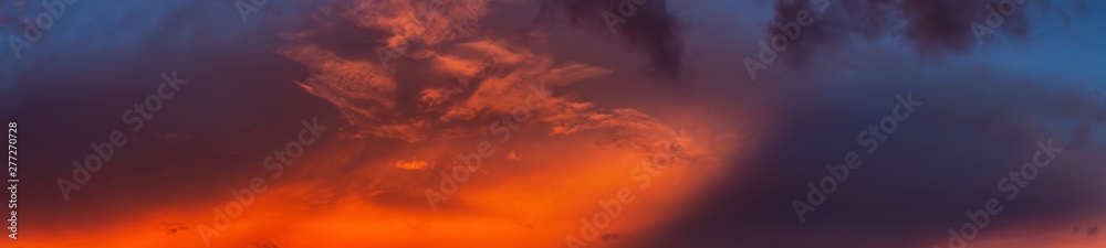 Dramatic Panoramic View of a cloudscape during a cloudy and colorful sunset. Taken over Beach Ancon in Trinidad, Cuba.