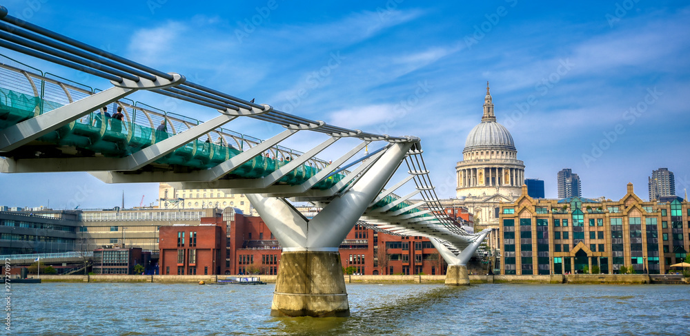 London, United Kingdom - April 18, 2019 - St. Paul's Cathedral across Millennium Bridge and the River Thames in London, UK.