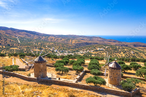 Typical landscape of Mirambellowith old windmills, olive treesand golden starch, Crete, Greece