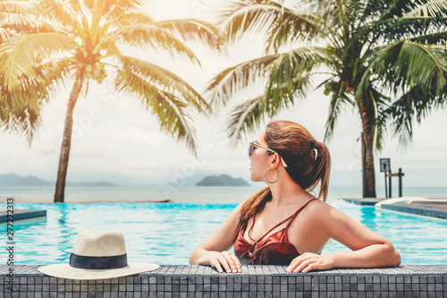 Carefree woman relaxation in swimming pool summer Holiday concept
