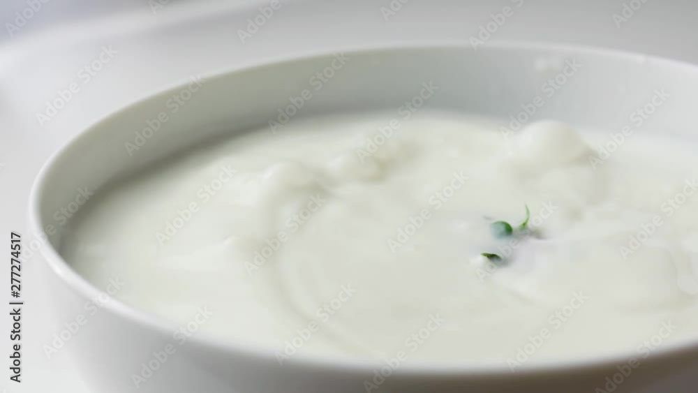 strawberry falling into bowl of milk in slow motion side view strawberry falling into bowl of milk in slow motion side view