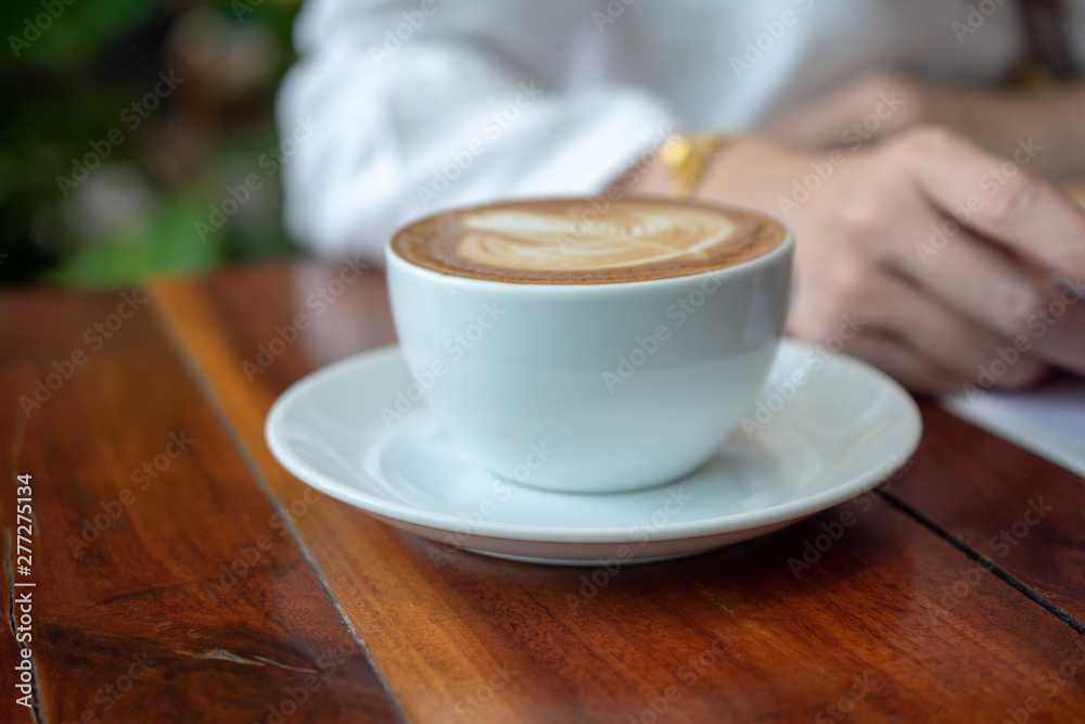 Coffee latte on wood table in coffee shop Coffee latte on wood table in coffee shop
