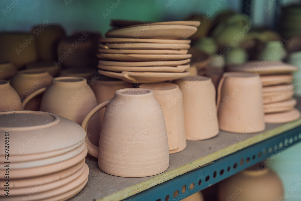Cups on the shelves in the pottery workshop Cups on the shelves in the pottery workshop