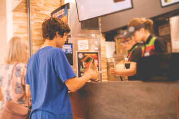 young man received his food package order in fastfood restaurant