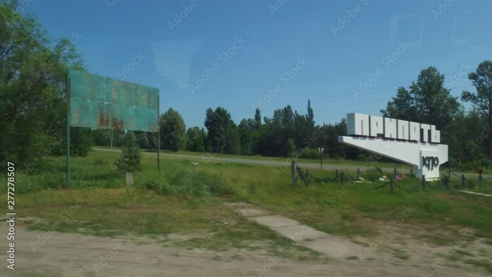 Driving by historical sign at the entrance to Pripyat, site of the catastrophic nuclear disaster that is a continuing environmental and ecological issue Driving by historical sign at the entrance to Pripyat, site of the catastrophic nuclear disaster that is a continuing environmental and ecological issue