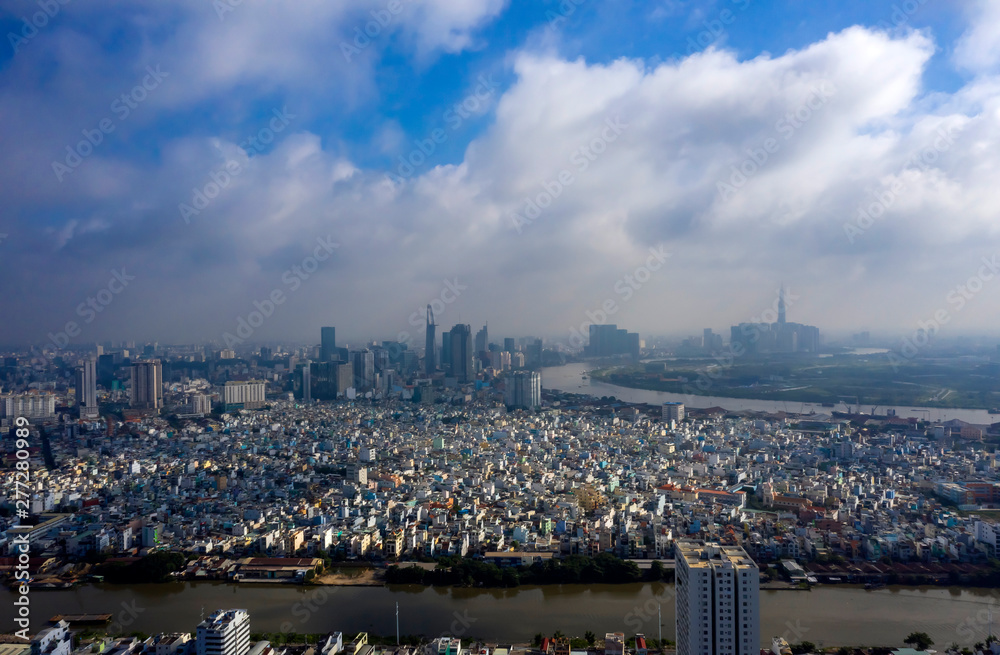 Obraz premium Early Morning Panorama of Ho Chi Minh City Vietnam. Often there is low cloud and mist in the morning at this time of the year. Photo taken from District 7 looking toward the City and Saigon River