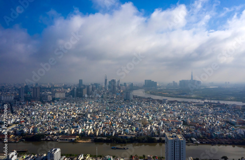 Early Morning Panorama of Ho Chi Minh City Vietnam. Often there is low cloud and mist in the morning at this time of the year. Photo taken from District 7 looking toward the City and Saigon River photo