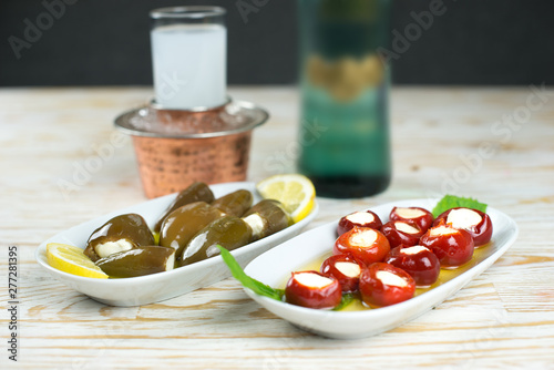 Traditional Turkish raki or greek ouzo with appetizers or snacks on the restaurant dinner table photo