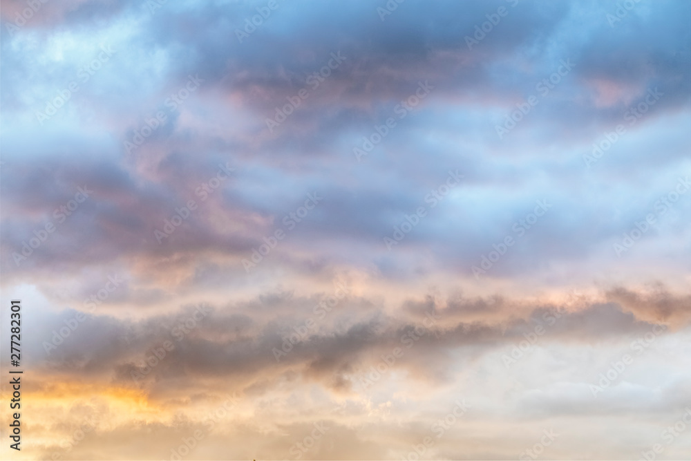 Colorful Soft Sunset Clouds - Gossamer clouds are painted soft hues by the setting sun. - obrazy, fototapety, plakaty 