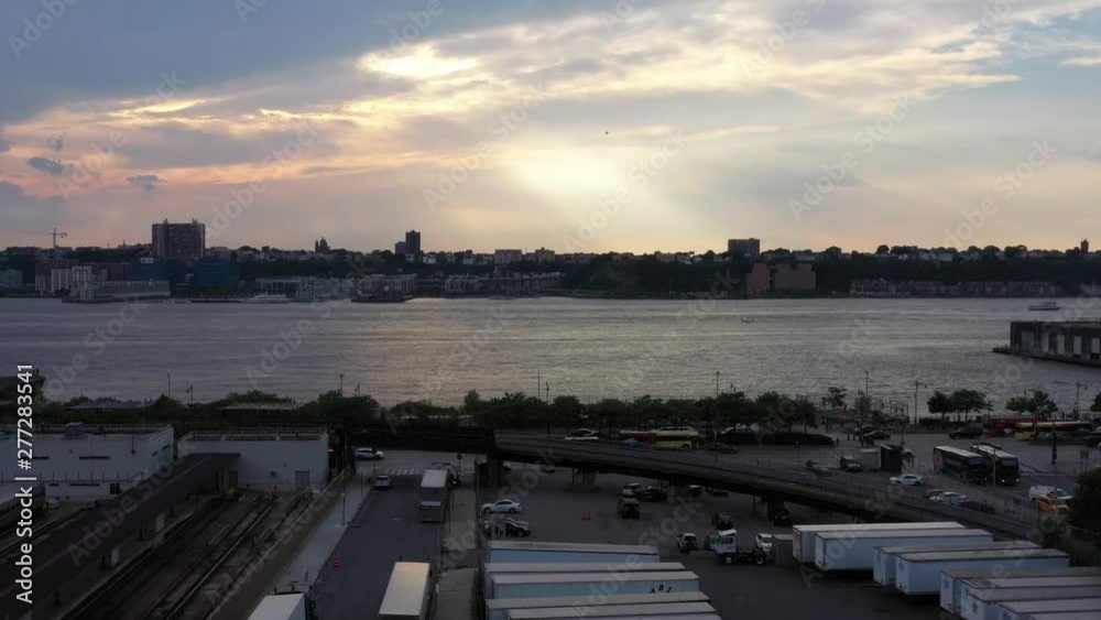 Slow rise up to a colorful sunset, as a bird flies to the left in Hudson Yards in New York Slow rise up to a colorful sunset, as a bird flies to the left in Hudson Yards in New York