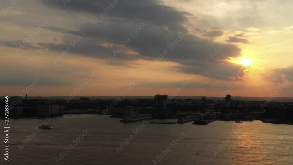 aerial drone shot, pan left showing a golden sunset from Hudson Yards, looking towards New Jersey aerial drone shot, pan left showing a golden sunset from Hudson Yards, looking towards New Jersey