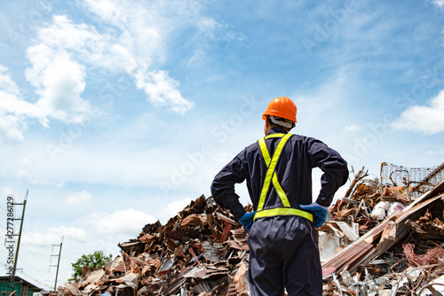 sanitation worker working in recycling plant Staff wearing reflective vests in an industrial interior
