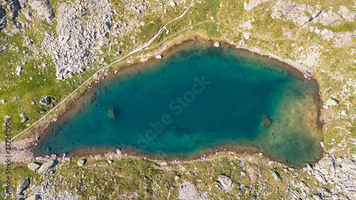 Fototapeta Naklejka Na Ścianę i Meble -  Italian Alps. Italy. Up and down drone aerial view of the a natural alpine lake. Orobie. Valgoglio lakes
