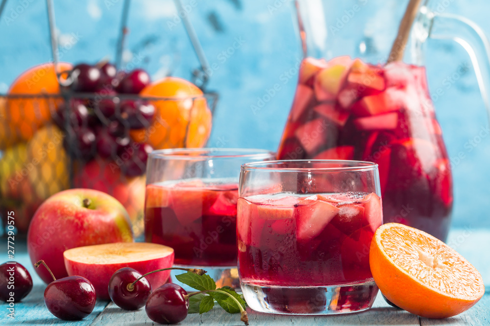 Refreshing sangria or punch with fruits in glasses and pincher - obrazy, fototapety, plakaty 
