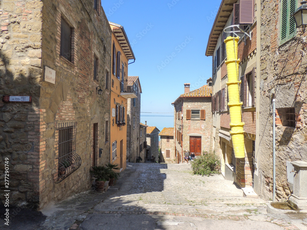 Alley of the ancient borgo of Monte del Lago in Umbria, Italy. The village that overlooks the Lake Trasimeno is sorrounded by defensive medieval walls.