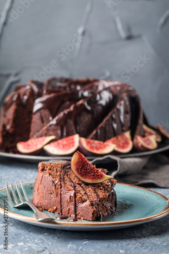 Gingerbread Bundt Cake for Christmas with figs and lingonberry over gray background