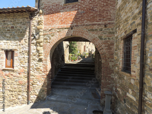 Alley of the ancient borgo of Monte del Lago in Umbria, Italy. The village that overlooks the Lake Trasimeno is sorrounded by defensive medieval walls.