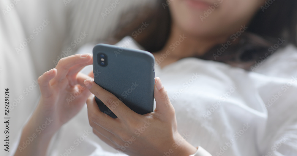 Woman use of mobile phone online at home - obrazy, fototapety, plakaty 
