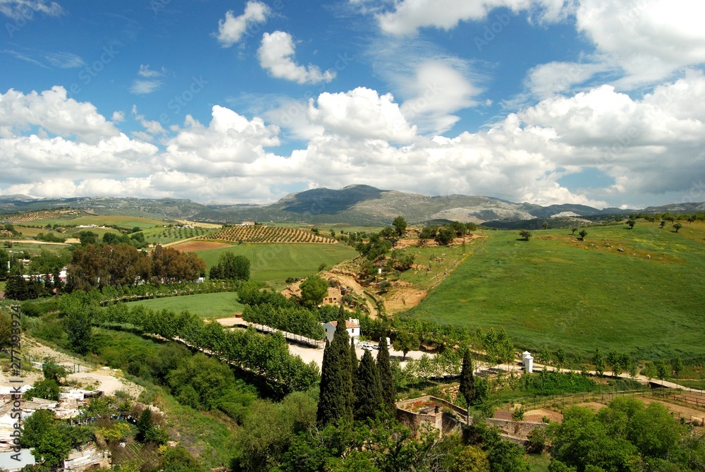Elevated view across farmland and the countryside towards the mountains, Ronda, Spain.