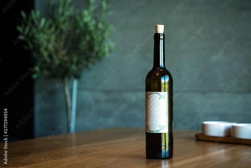 Fototapeta premium Pouring red wine on a wooden oak table