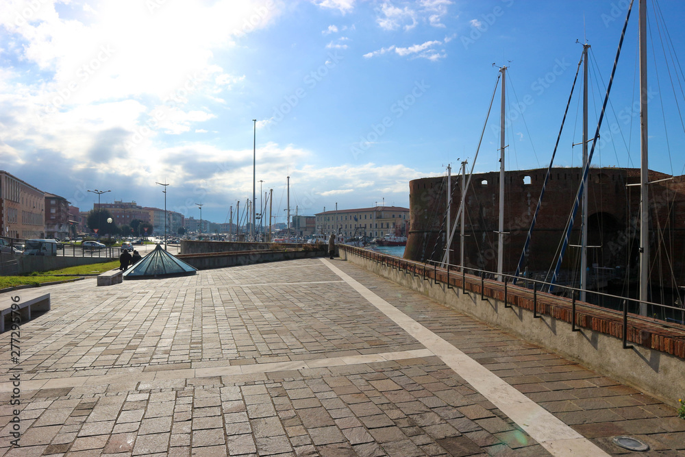 View to Livorno harbour with lot of masts and old fortress