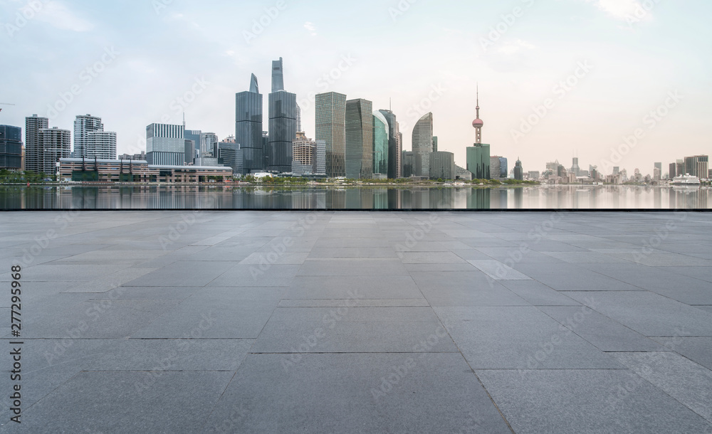 Obraz premium Urban skyscrapers with empty square floor tiles