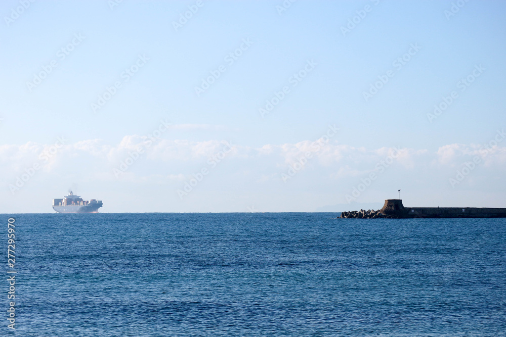 Large container ship in the Ligurian sea enter the port of Livorno, Italy