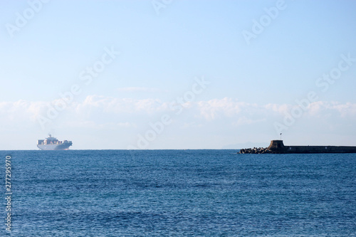 Large container ship in the Ligurian sea enter the port of Livorno, Italy