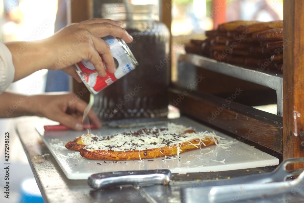 Pisang goreng, fried banana with cheese, chocolate and condensed milk from a street food stall in Bandung, Indonesia