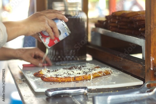 Pisang goreng, fried banana with cheese, chocolate and condensed milk from a street food stall in Bandung, Indonesia
