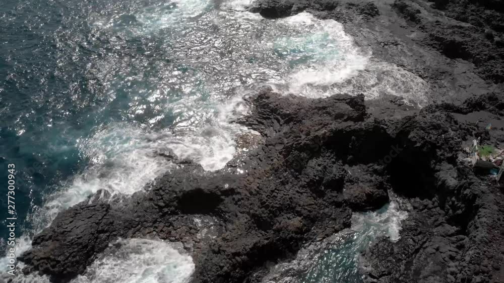 Aerial shot of the coast on the island of Gran Canaria of water hitting the rocks