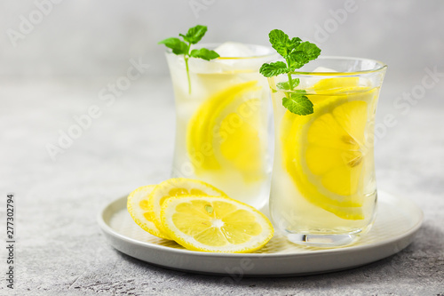 Iced lemon mint tea with ginger and honey. Selective focus, space for text.