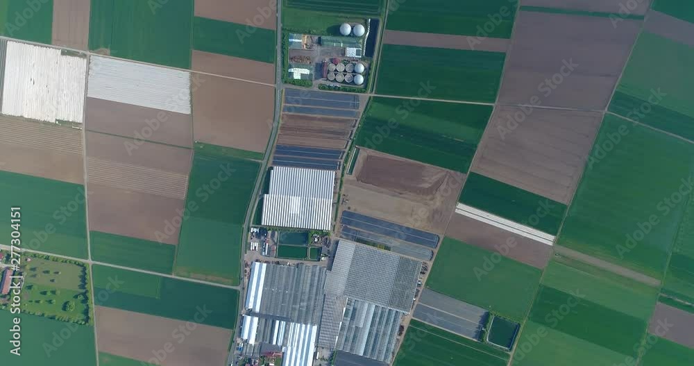 European city near greenhouses, a large greenhouse complex near the European village, Google Maps illusion
