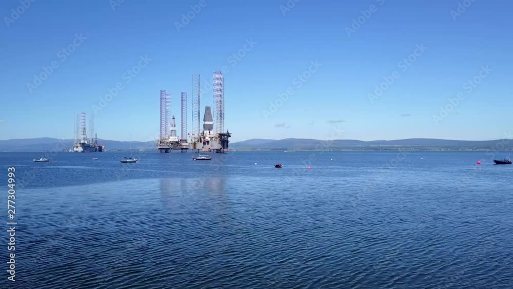 Drone Low Pass Infront Of Sail Boats With Oil Rigs In The Background Drone Low Pass Infront Of Sail Boats With Oil Rigs In The Background