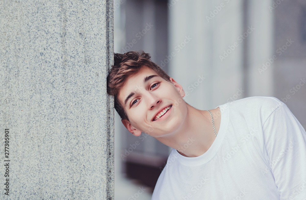 Cheerful handsome man laughing and looking at camera with smile