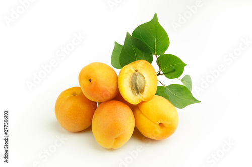 Orange fresh apricots with green leaves
