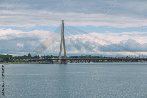 City Riga, Latvia Republic. Urban city cable bridge and river. Old metal constructions. July 4. 2019