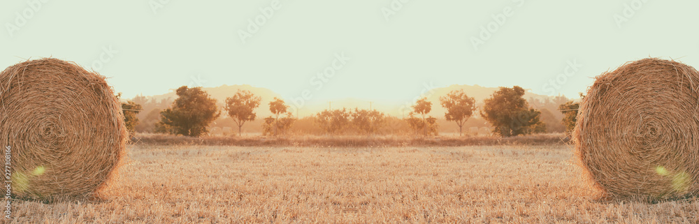 Haystack on the field. Sunset time. Harvest season. Long banner photo. Header format. Haystack on the field. Sunset time. Harvest season. Long banner photo. Header format.