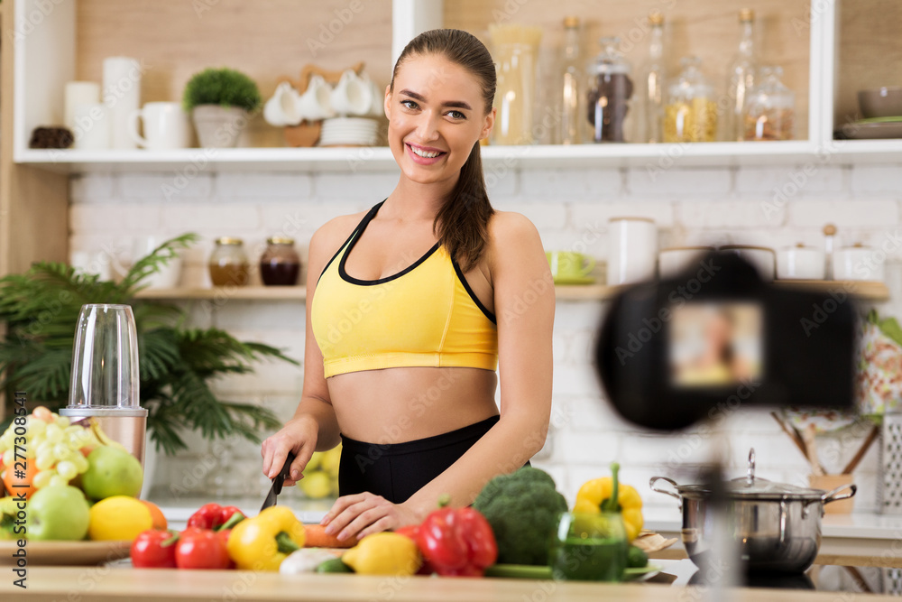Healthy vlog. Slim woman cooking salad for new vlog, recording video Healthy vlog. Slim woman cooking salad for new vlog, recording video
