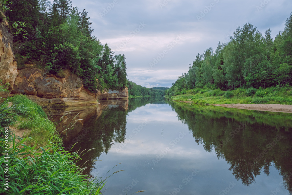 City Cesis, Latvia Republic. Red rocks and river Gauja. Nature  and green trees in summer. July 4. 2019 Travel photo.