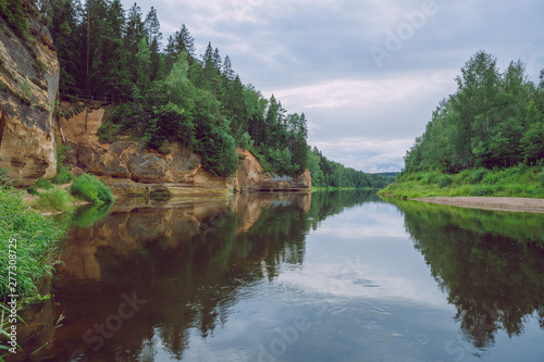 City Cesis  Latvia Republic. Red rocks and river Gauja. Nature  and green trees in summer. July 4. 2019 Travel photo.