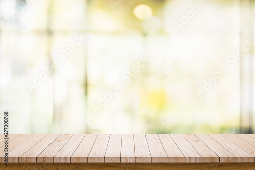 Empty wooden table with blur living room interior background.