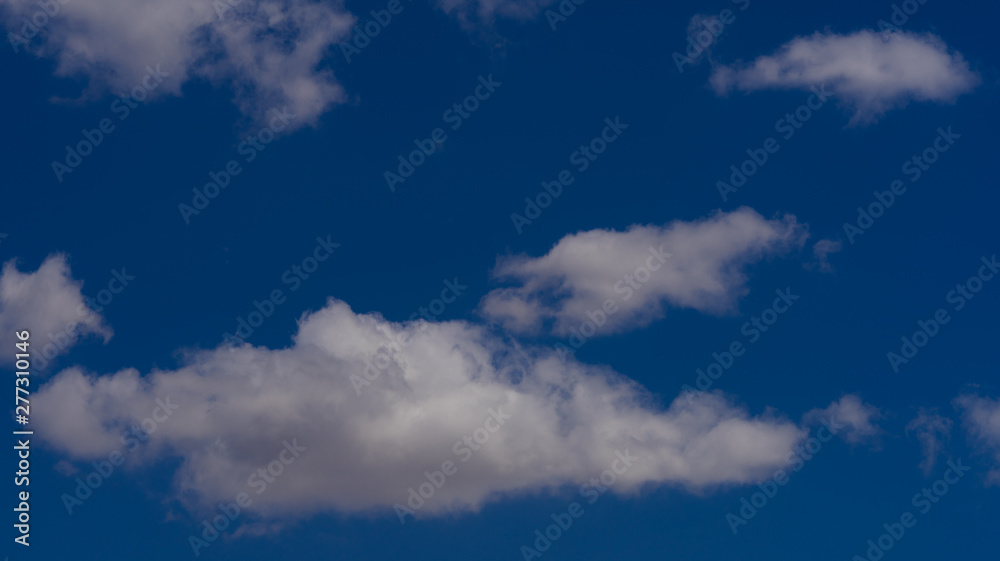 Fototapeta premium white clouds float across the blue sky