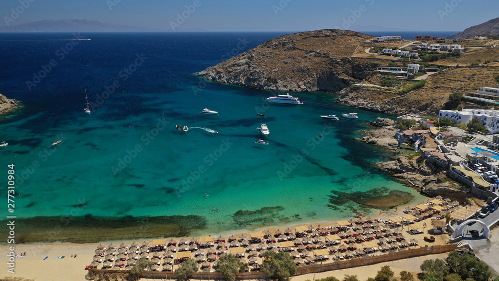 Obraz premium Aerial drone photo of small peninsula with picturesque chapel and beach of Agia Anna as well as small beach of Divounia, island of Mykonos, Cyclades, Greece