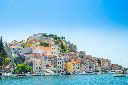 City of Sibenik on the Adriatic coast in Dalmatia, Croatia, fishing and sailing boats in harbor, old town in background photo