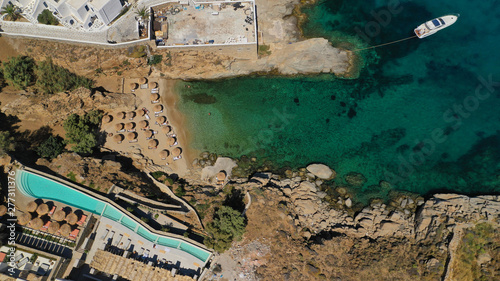 Aerial drone photo of small peninsula with picturesque chapel and beach of Agia Anna as well as small beach of Divounia, island of Mykonos, Cyclades, Greece © aerial-drone