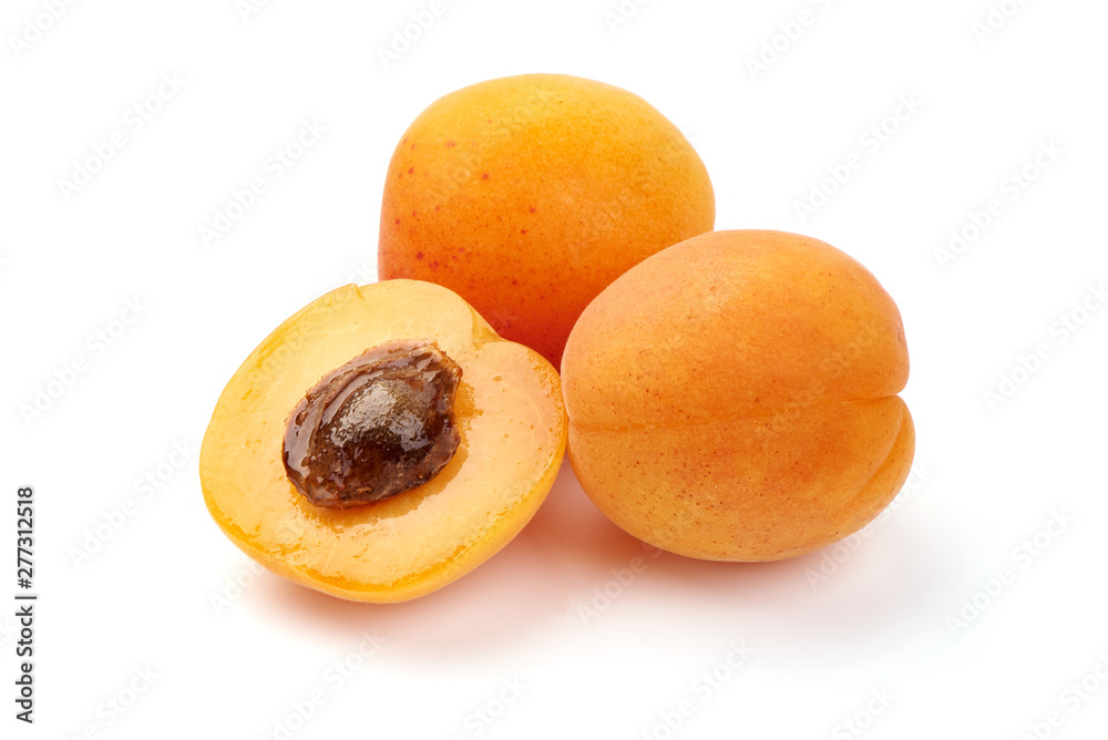 Fresh apricot fruits with juicy half, ripe nectarines, close-up, isolated on white background Fresh apricot fruits with juicy half, ripe nectarines, close-up, isolated on white background