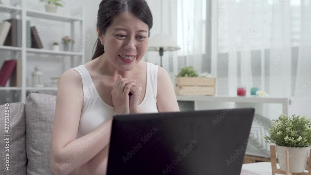 expectant lady cheerful chatting on video phone call by laptop computer on sofa showing camera ultrasound scan photo of her baby. young pregnant woman smiling take sonogram share happiness to friend expectant lady cheerful chatting on video phone call by laptop computer on sofa showing camera ultrasound scan photo of her baby. young pregnant woman smiling take sonogram share happiness to friend