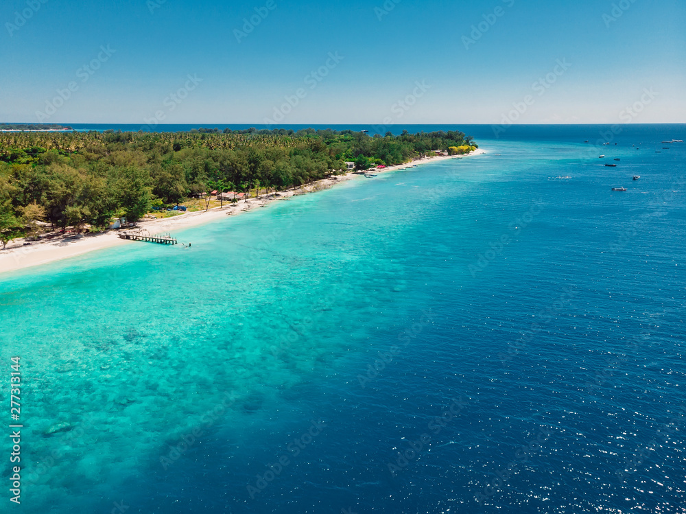 Tropical beach with turquoise ocean in paradise island. Aerial view. Paradise holiday resort