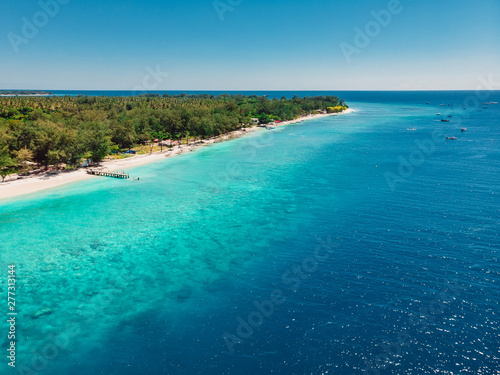 Fototapeta Naklejka Na Ścianę i Meble -  Tropical beach with turquoise ocean in paradise island. Aerial view. Paradise holiday resort